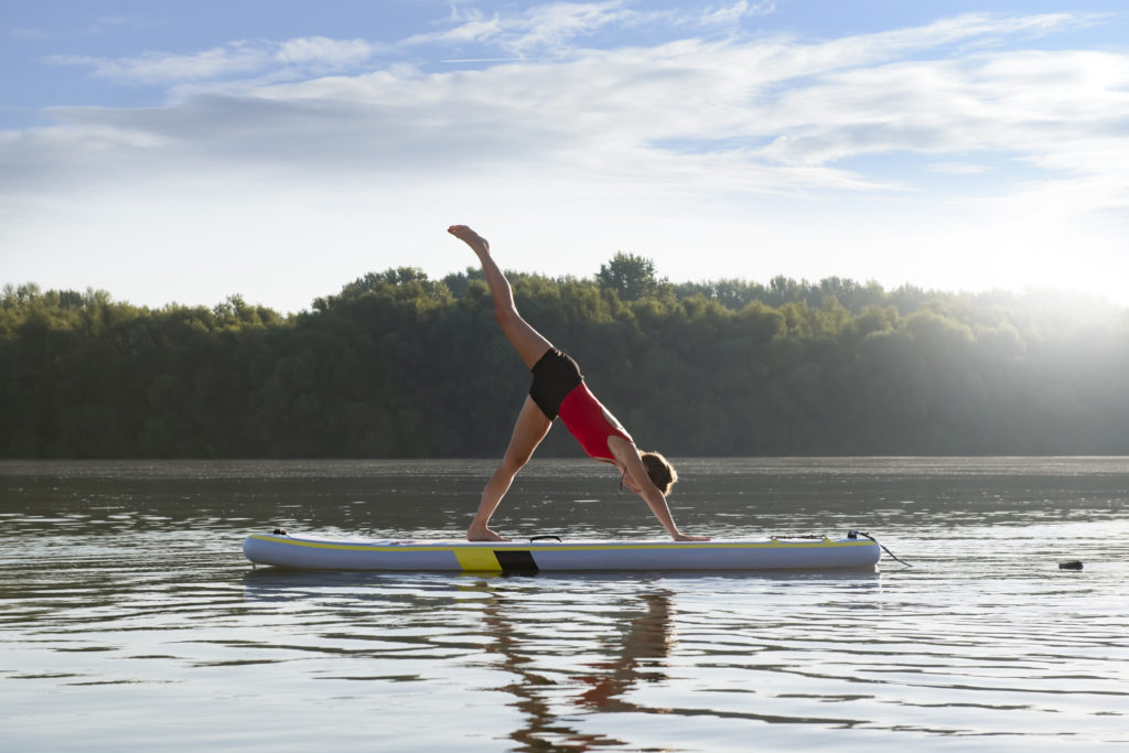 Practicing paddleboard yoga, a great idea to start the celebration of the 4th of July